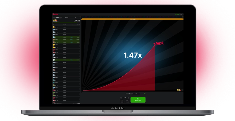 The Aviator game interface on the laptop screen