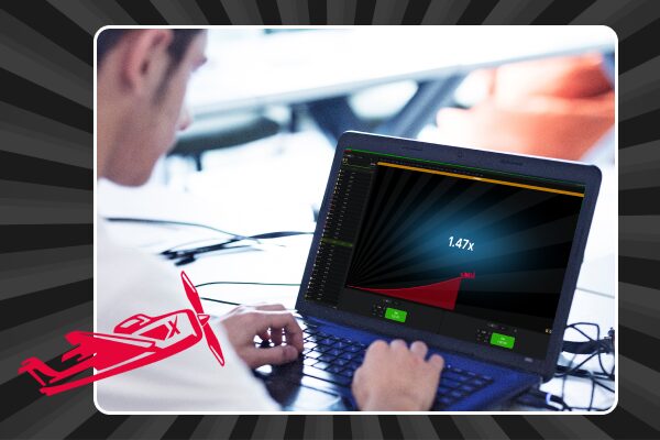 man looking at laptop screen with Aviator game